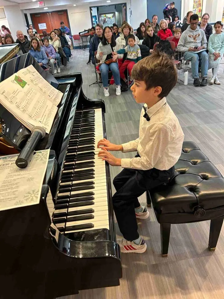 An Allegro Music School student showcases her skills on the piano during the Winter Recital 2024, impressing the gathered audience