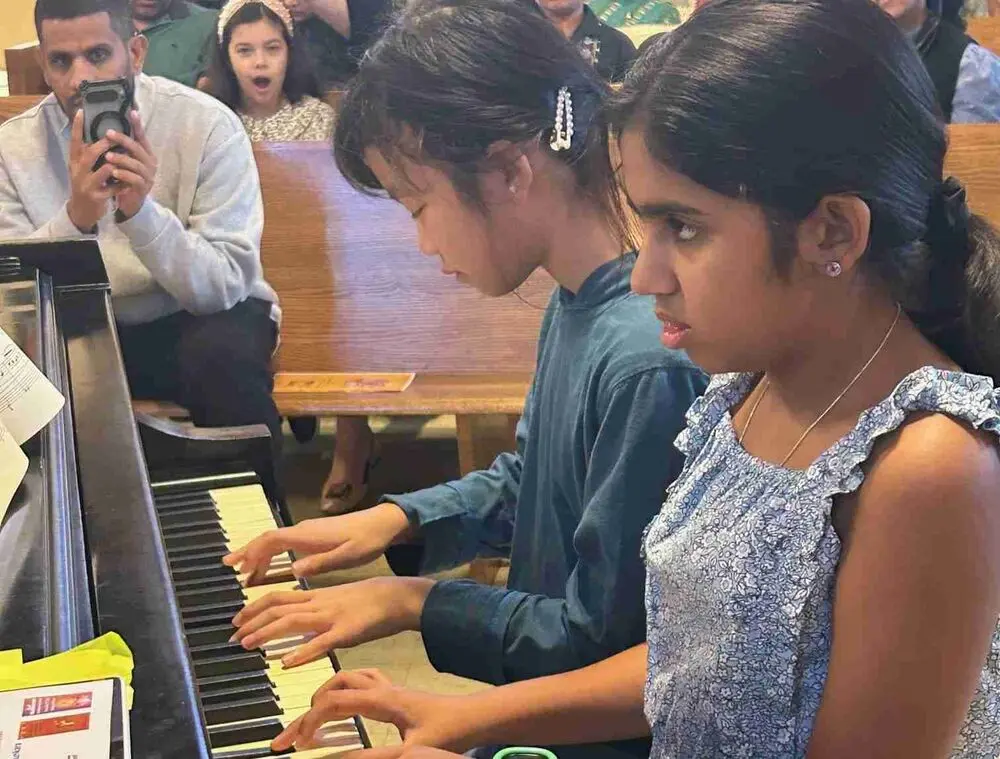 Teamwork on the keys during a delightful piano duet performance.